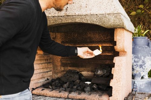 man-burning-firepit-with-paper (1)
